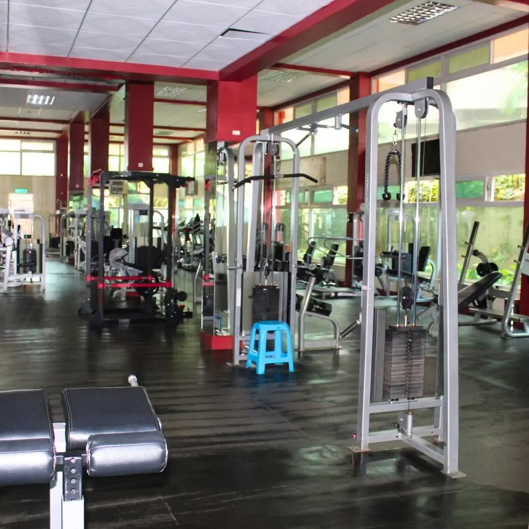 Spacious gym with red pillars and modern fitness equipment