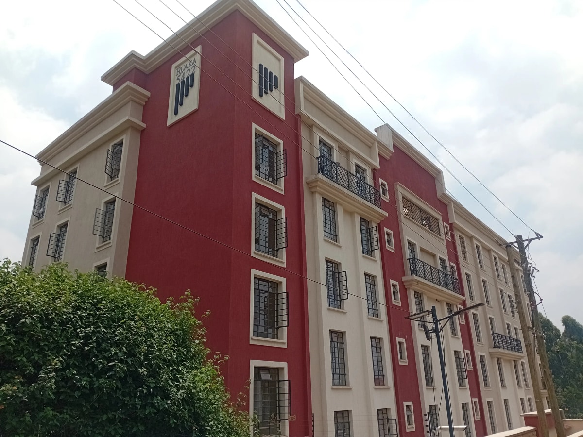 Multi-story residential building with red and cream facade