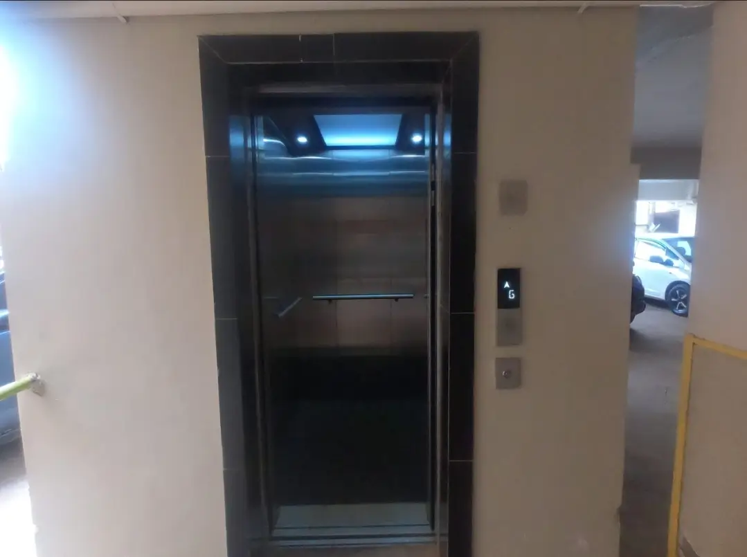 Modern elevator in building lobby with stainless steel doors