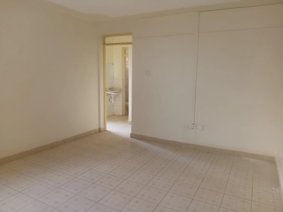 Spacious bedroom with en-suite bathroom access visible