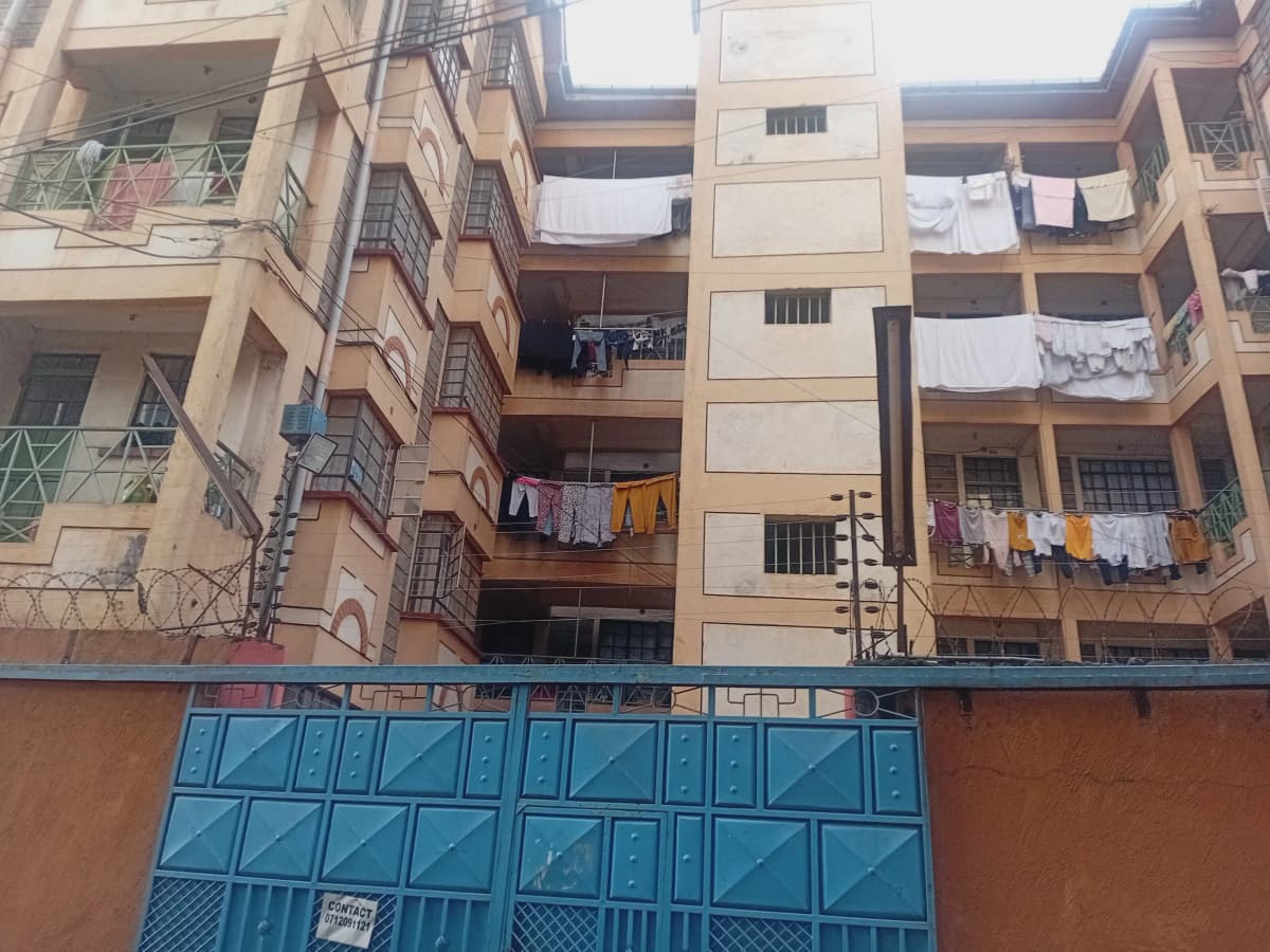 Multi-story residential building facade with clotheslines and balconies