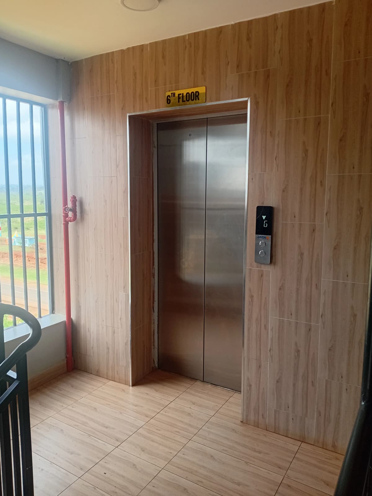 Building lobby with elevator and wood-paneled walls