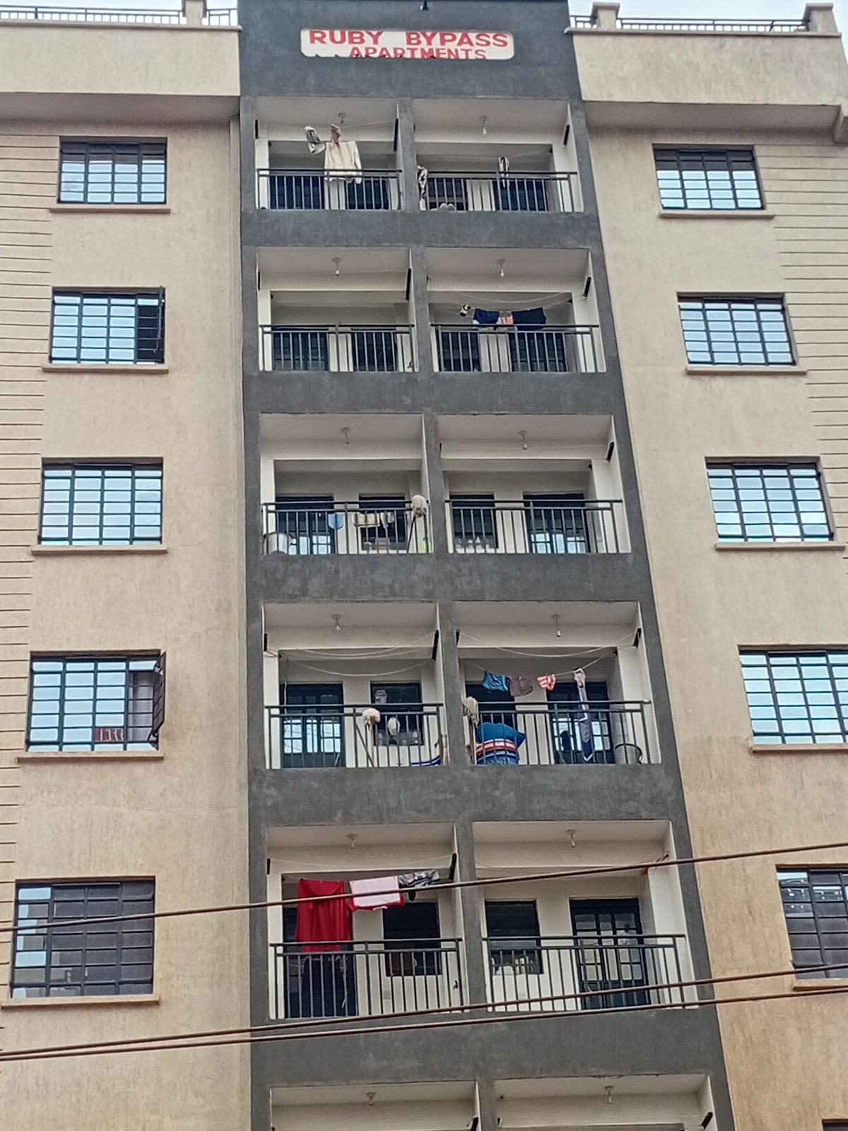 Multi-story residential building facade with balconies and windows