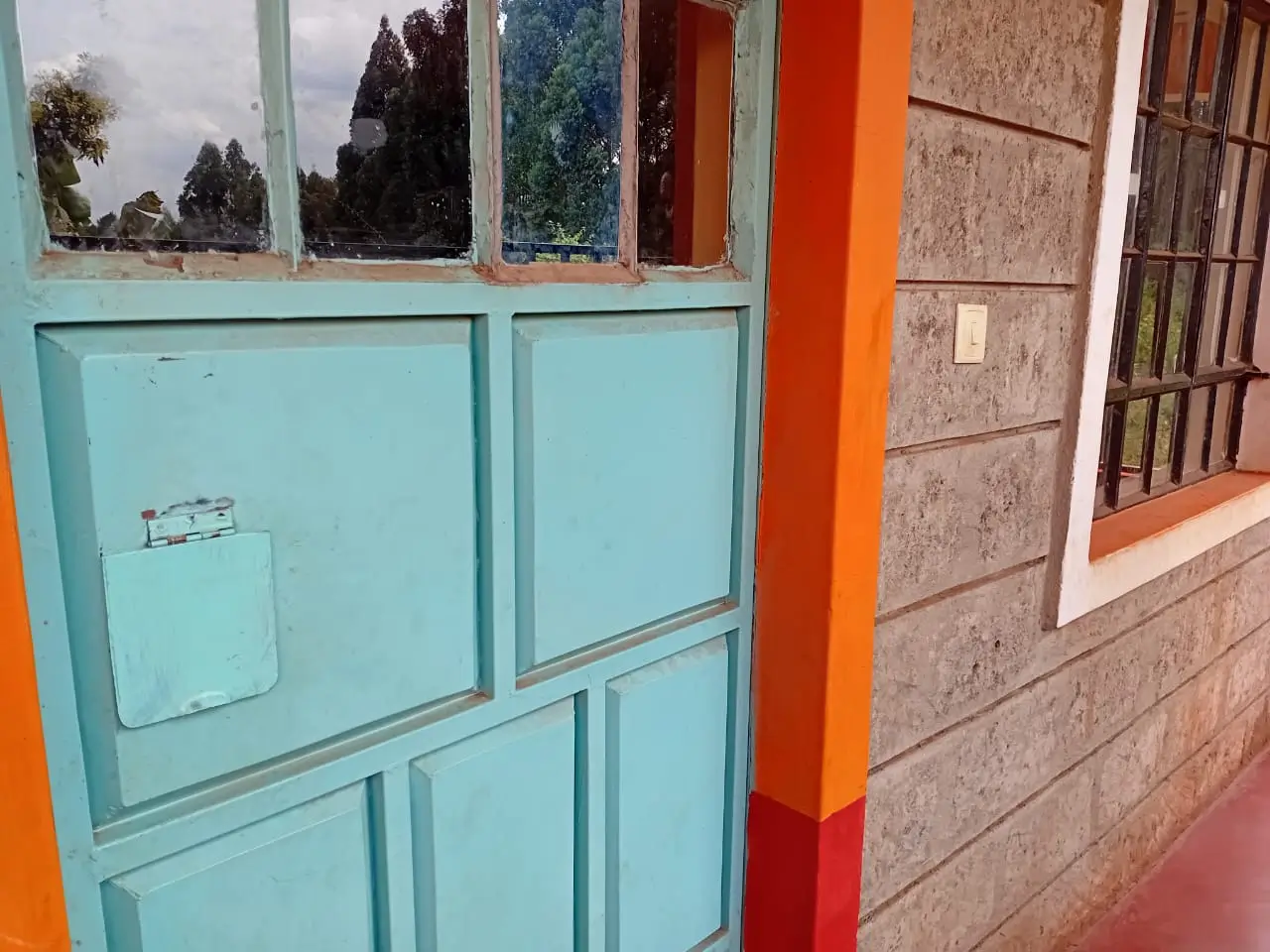 Building facade with turquoise windows and orange trim