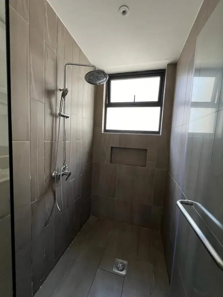 Modern bathroom with rainfall shower and natural light window
