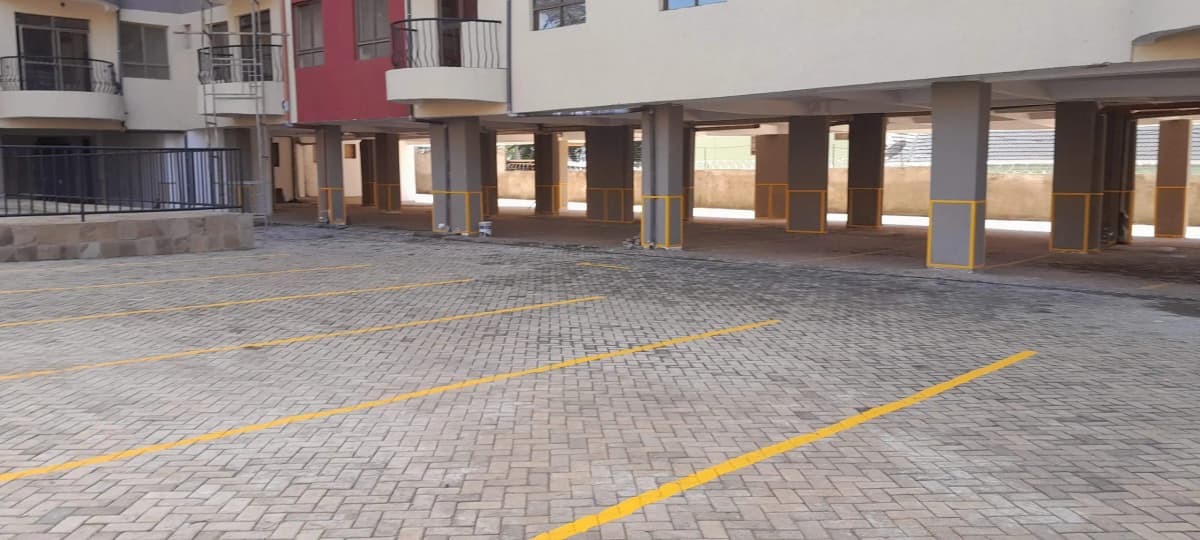 Ground-level parking area with yellow directional markings