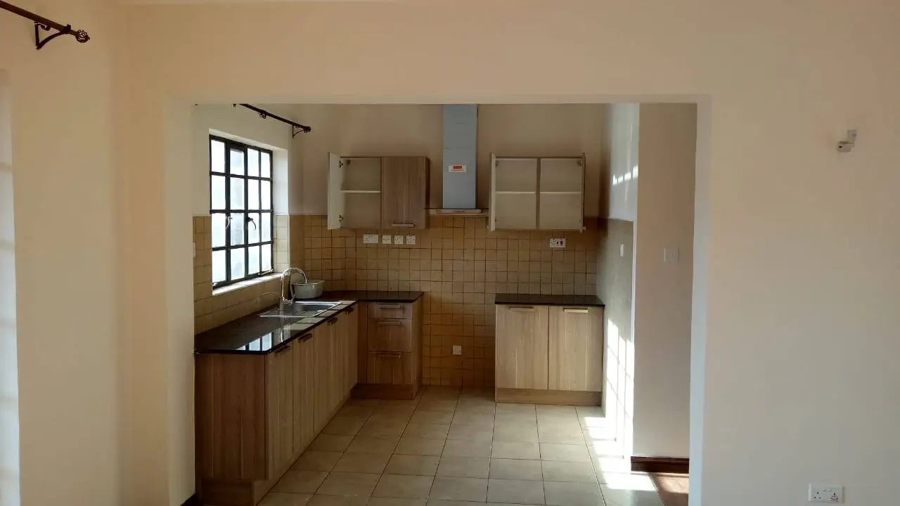 Spacious kitchen with wooden cabinets and tiled backsplash
