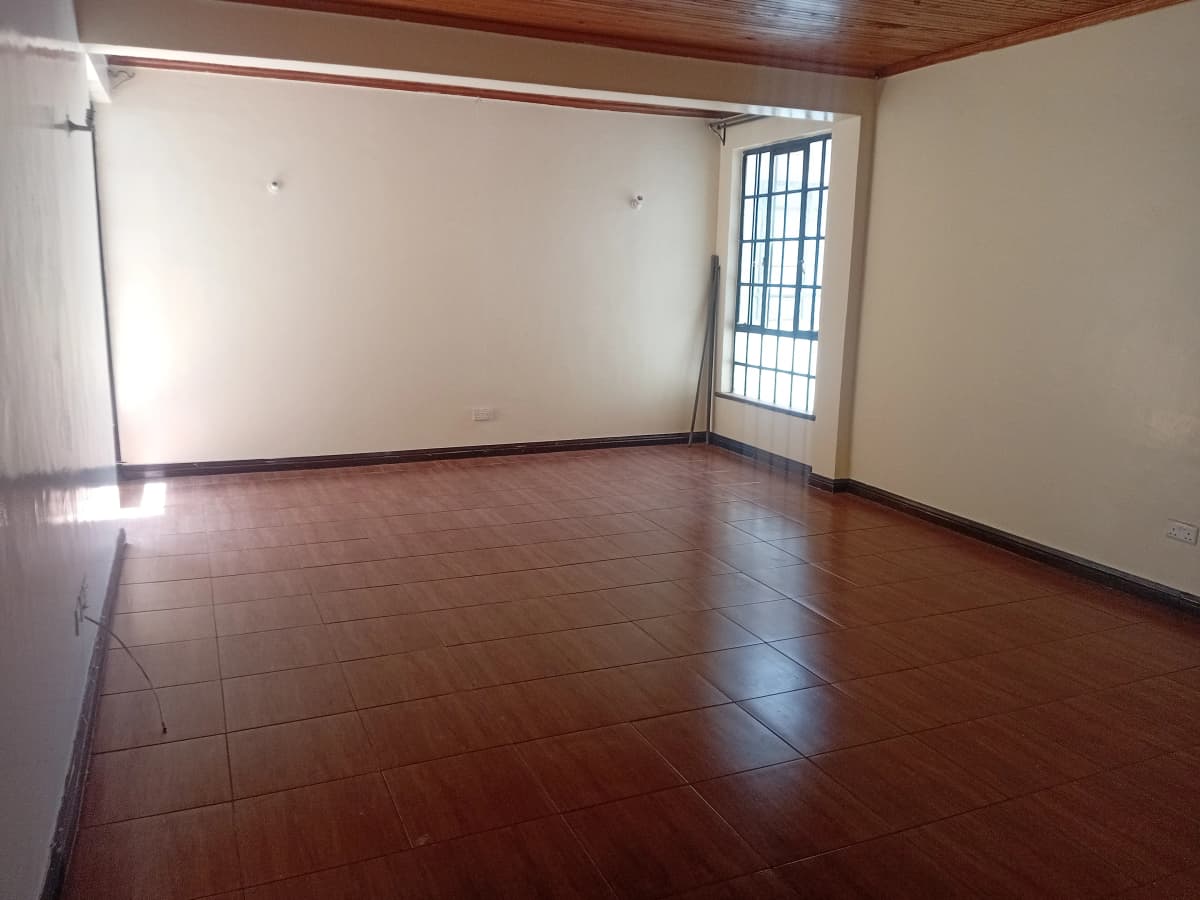 Spacious empty living room with polished wooden floors