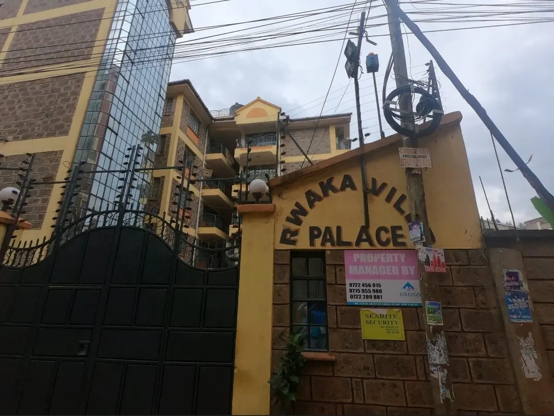 Yellow multi-story residential building facade with signage