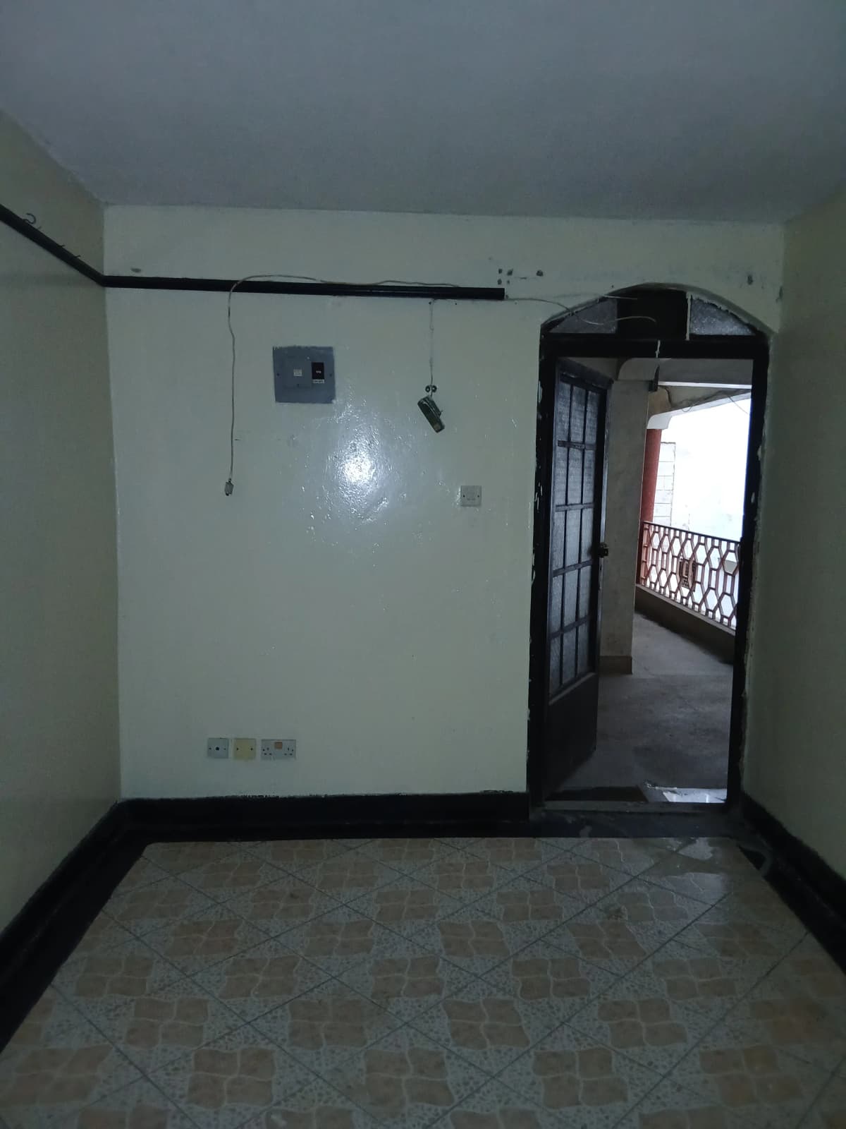 Minimalist corridor with tiled flooring and arched doorway