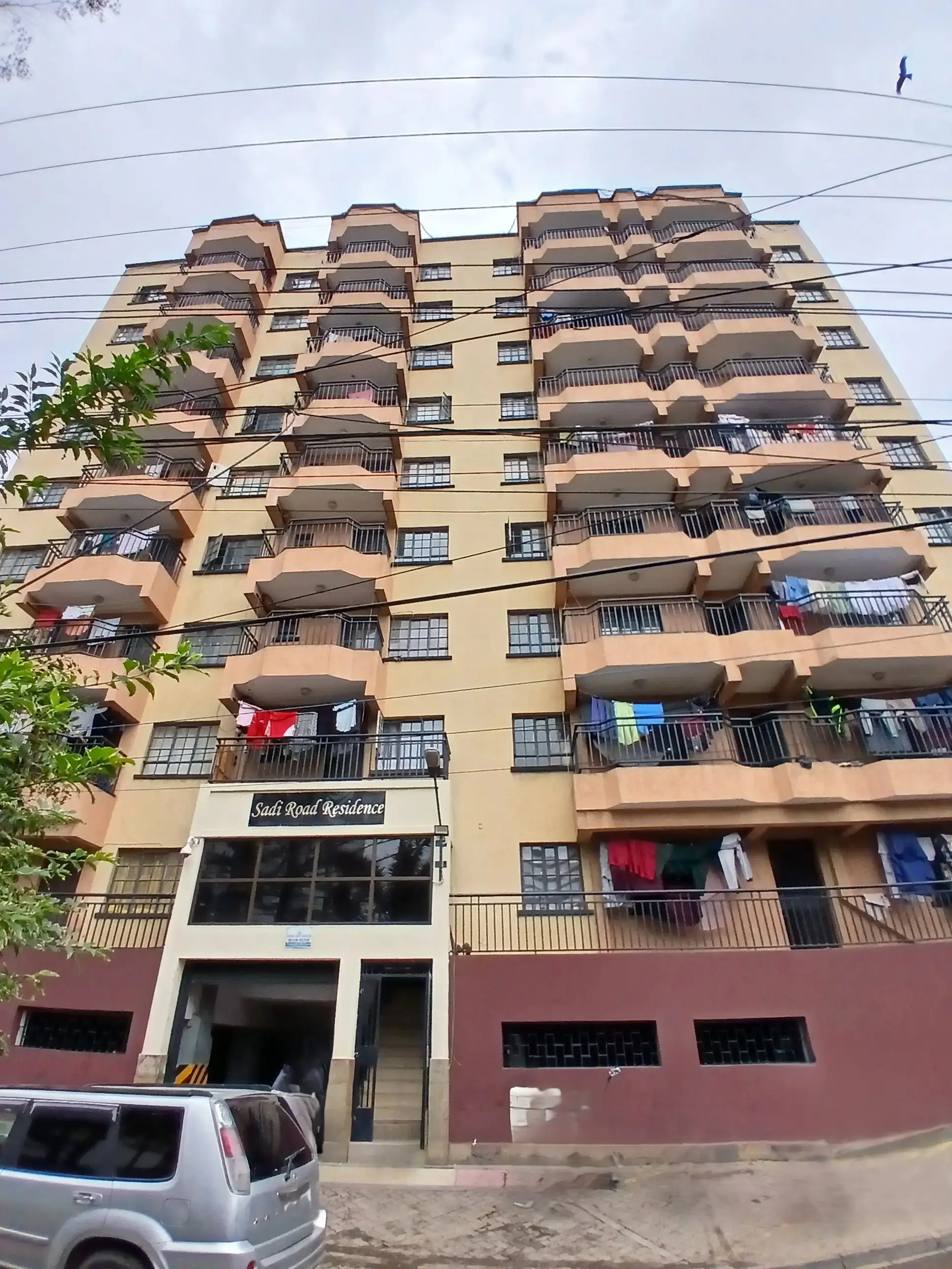 Multi-story residential building facade with curved balconies