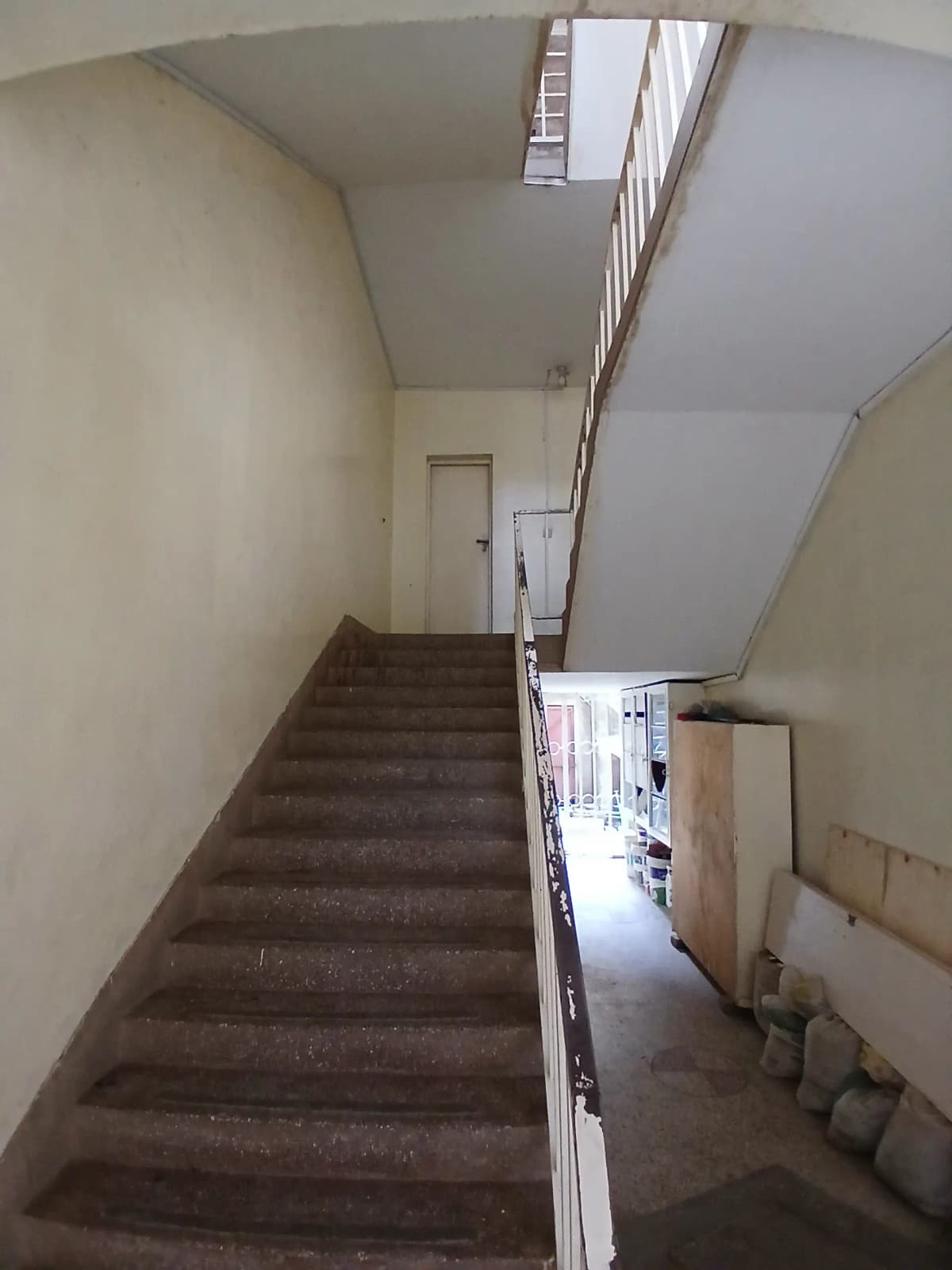 Interior stairwell with natural light and handrail