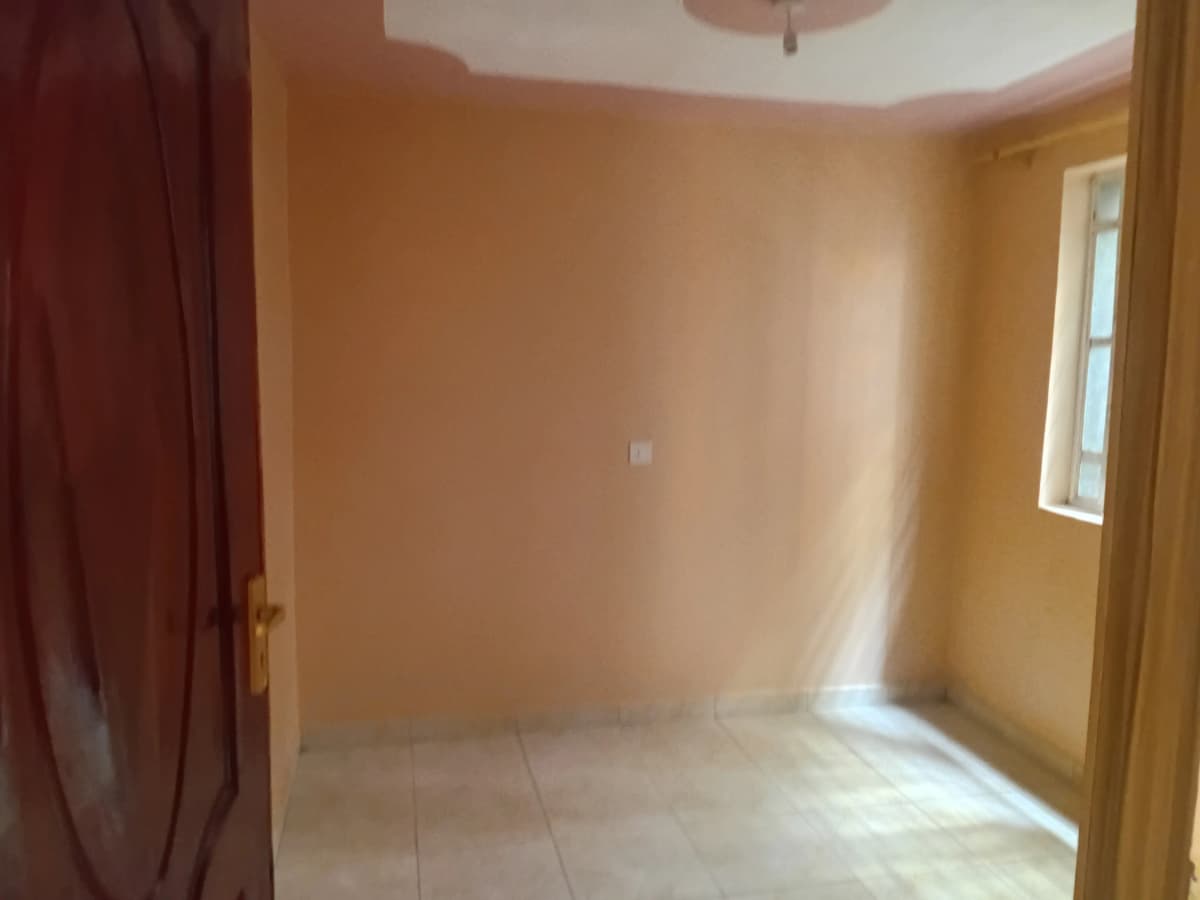 Empty bedroom with peach walls and natural light