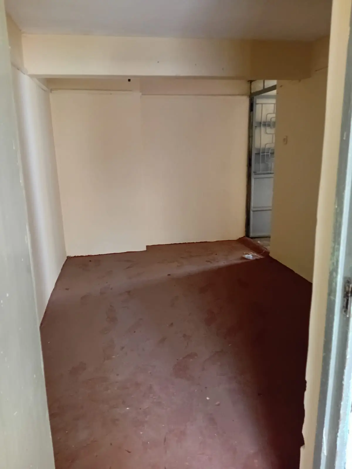 Small enclosed storage room with concrete floor