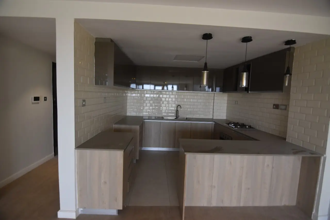 Modern kitchen with island, black cabinets, subway tile backsplash