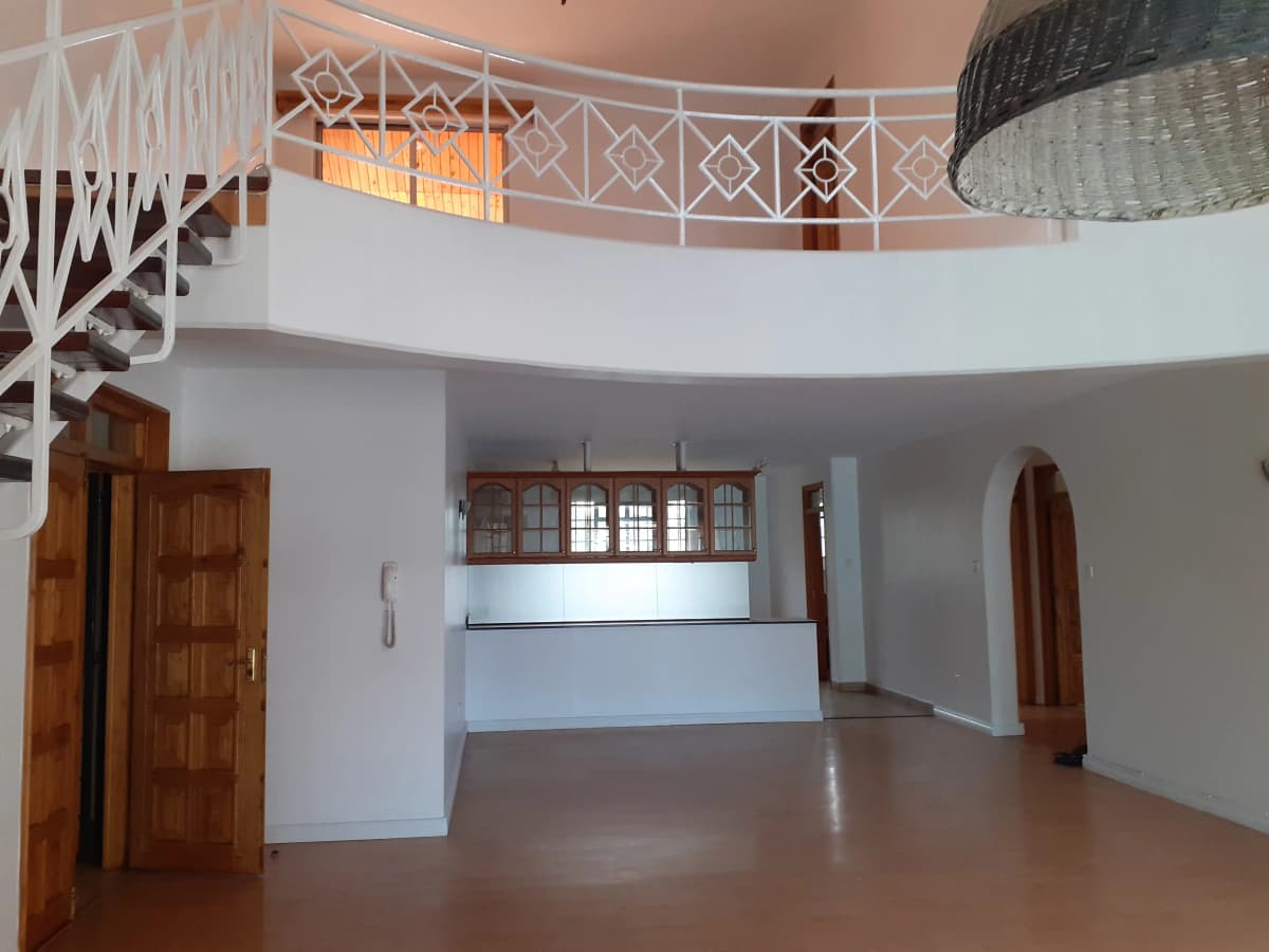 Spacious open-plan living area with mezzanine level above