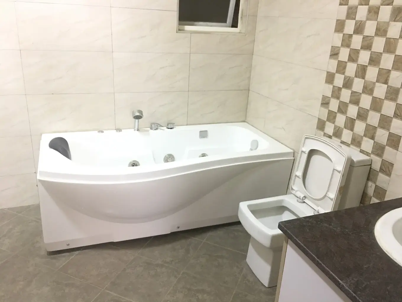 Modern bathroom with jacuzzi tub and toilet