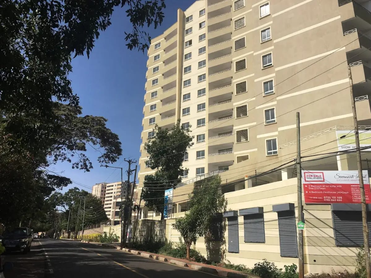 Multi-story residential building facade with ground-floor retail units