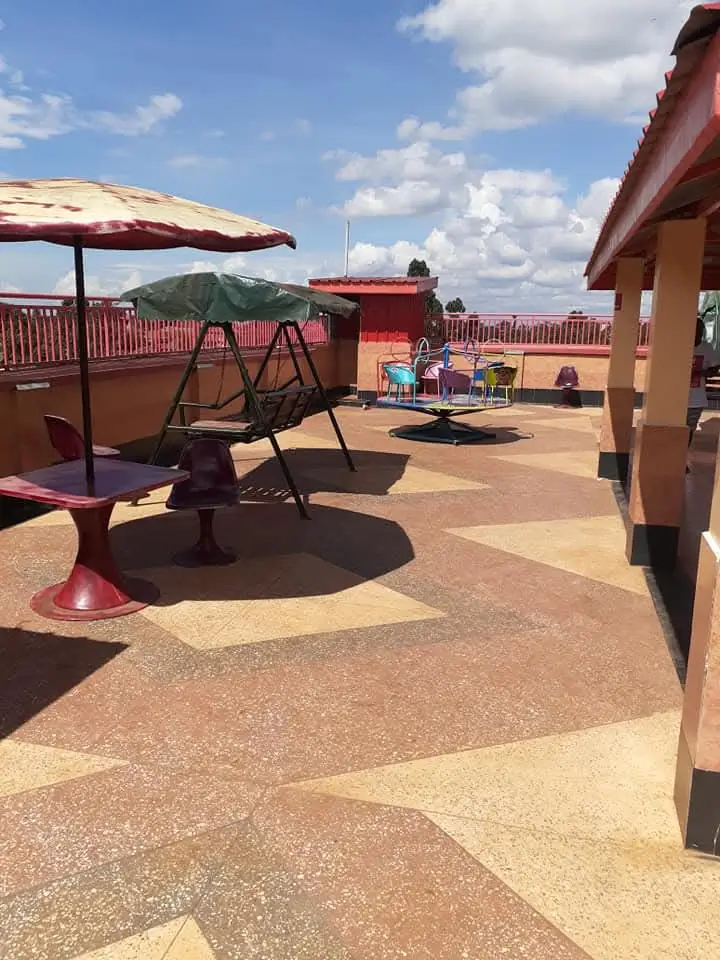 Rooftop terrace with play area, swing, and mountain views