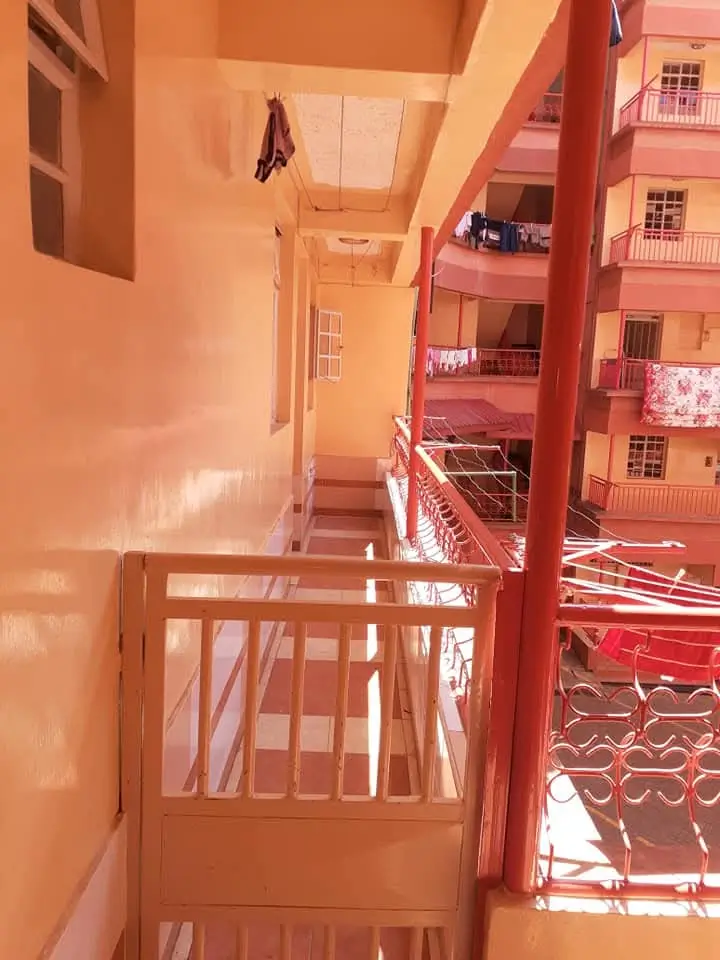 Narrow balcony overlooking adjacent residential building complex