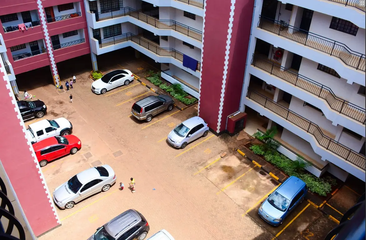 Multi-level apartment complex with shared parking compound