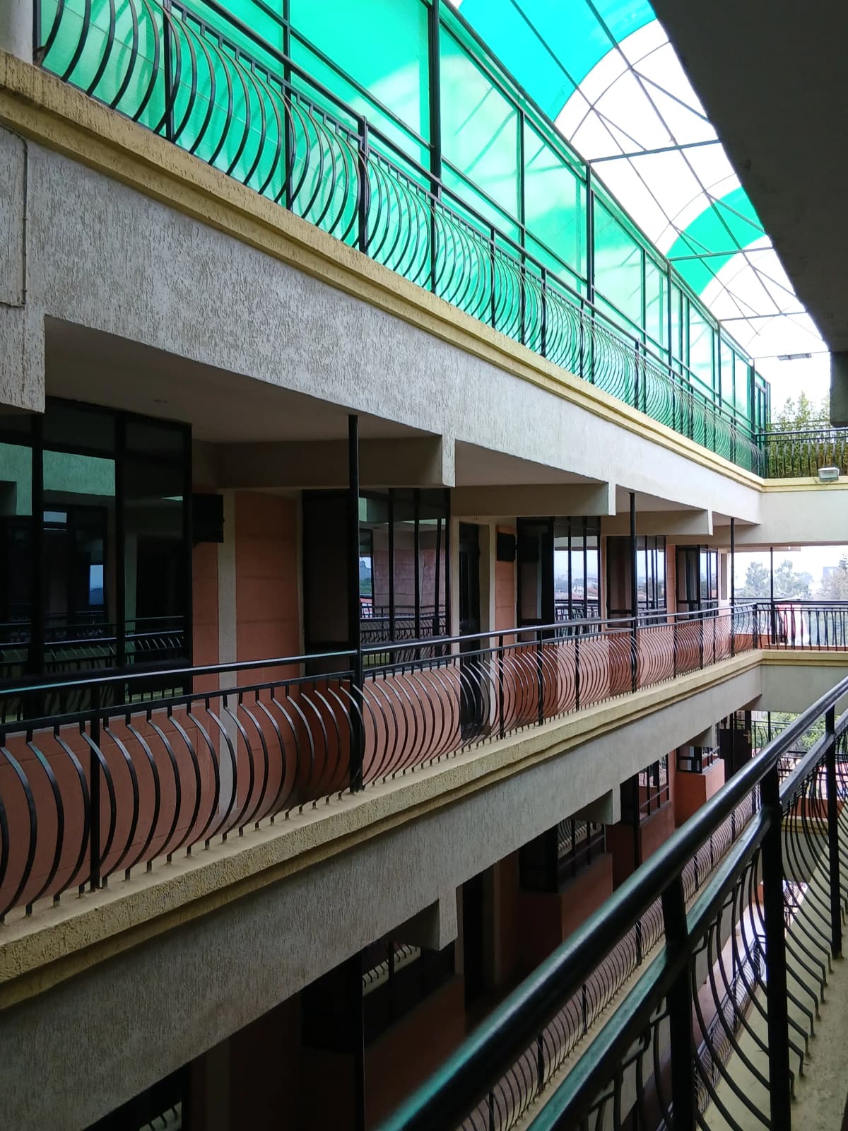 Multi-level balcony with metal railings and glass panels