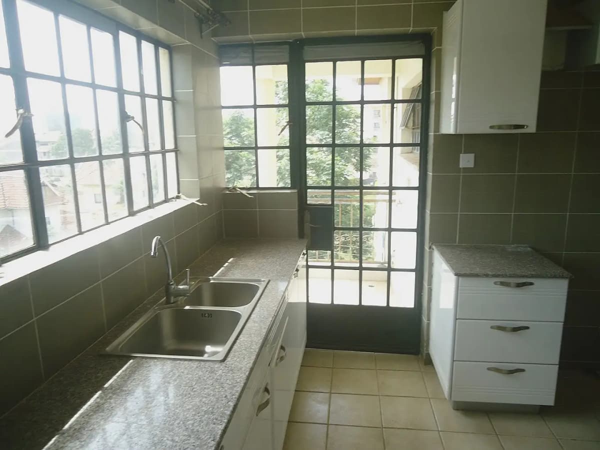 Galley kitchen with sink, countertop, and garden view doors