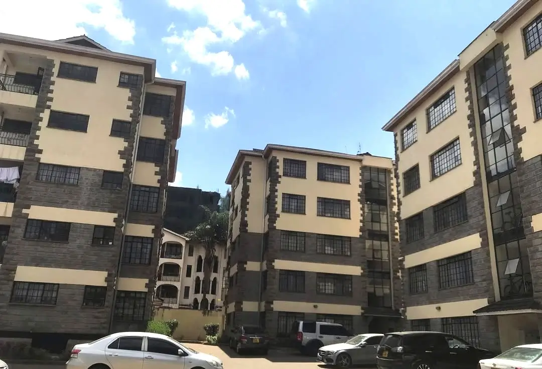 Multi-story residential building complex with parking area