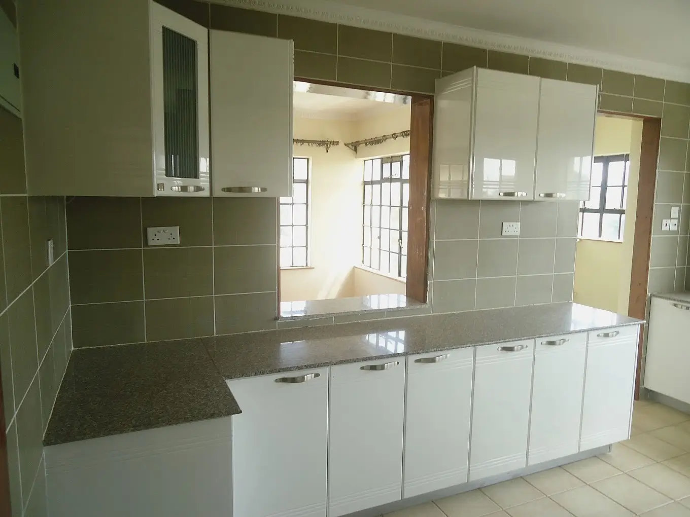 Modern kitchen with white cabinets and dark countertops