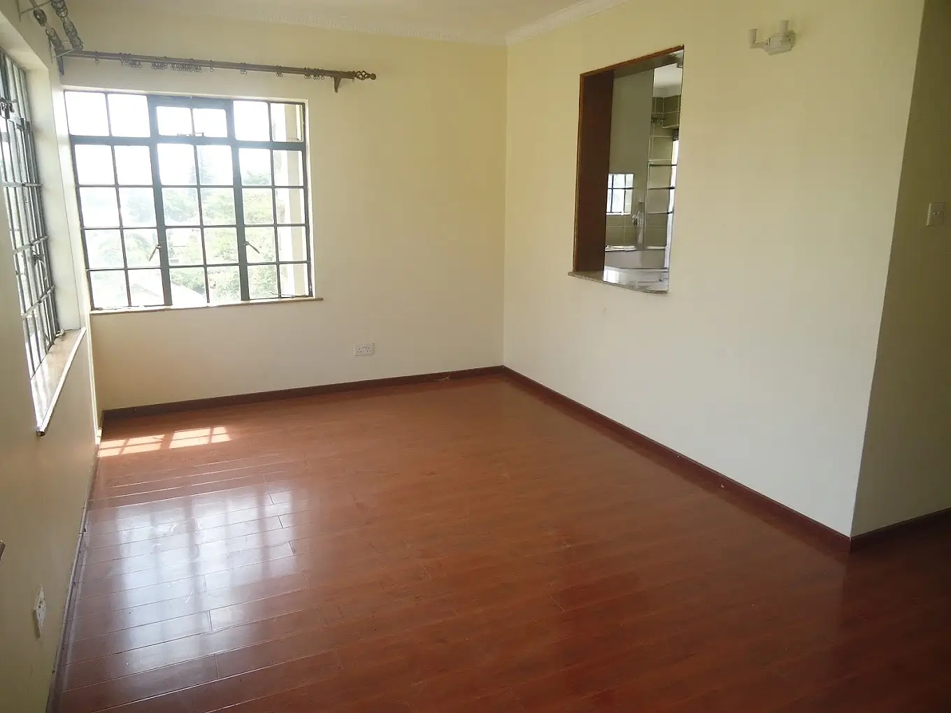 Bright empty living room with polished wooden floor