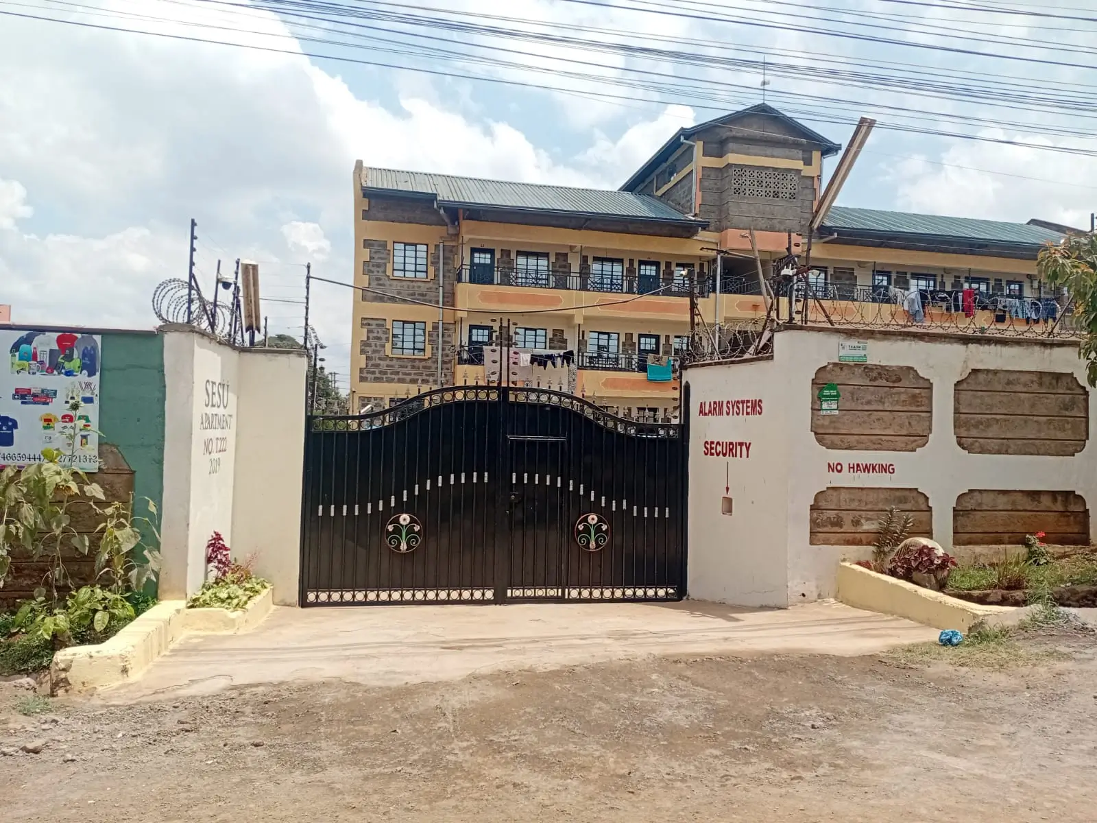 Property compound entrance with security gate and fence