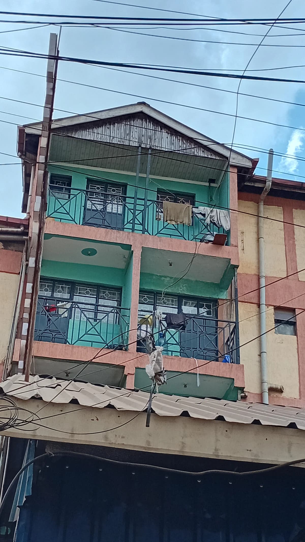 Multi-story residential building facade with green shutters
