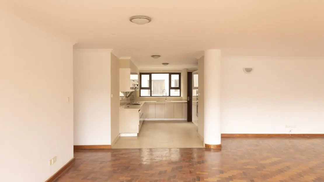 Open-plan living room with integrated kitchen area visible