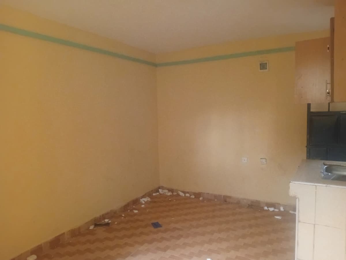 Empty bedroom with yellow walls and wooden flooring