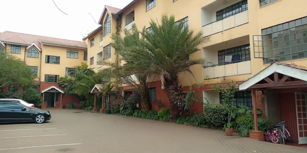 Multi-story residential compound with parking and landscaping