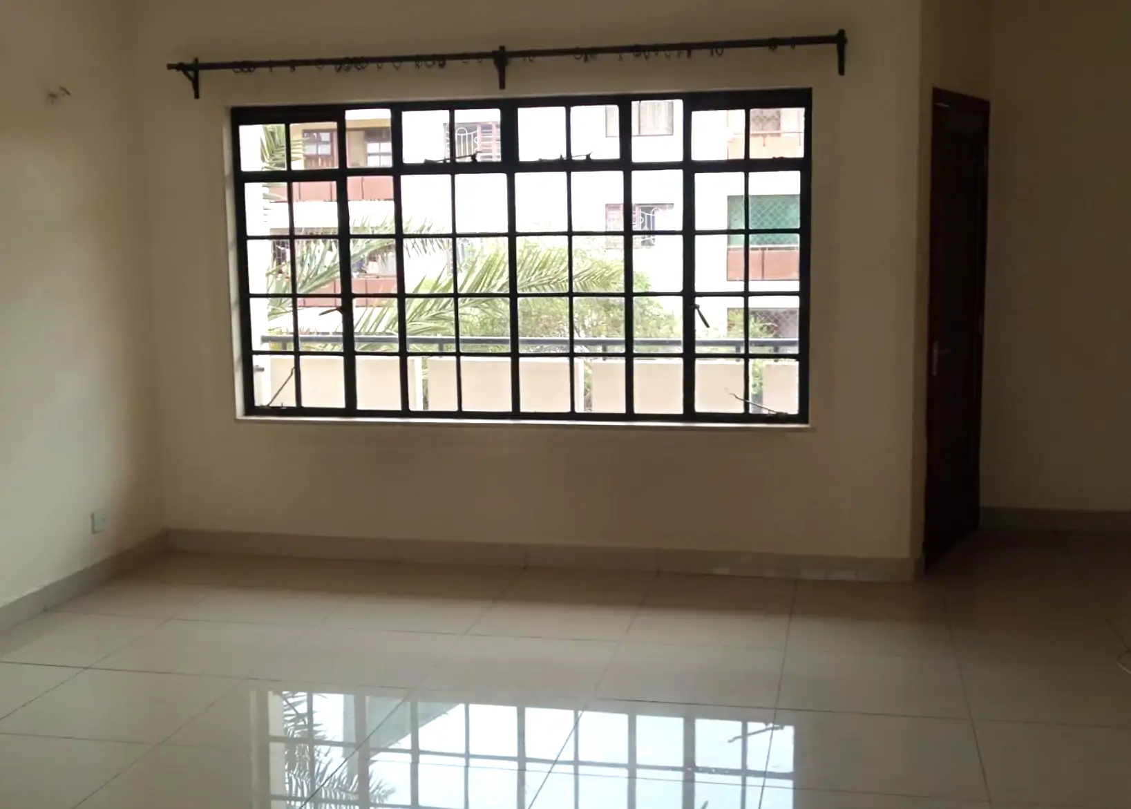 Spacious empty living room with large grid windows
