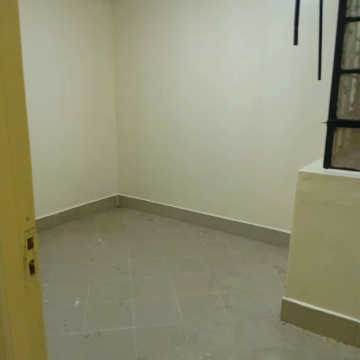 Empty room with concrete floor, minimal fixtures visible