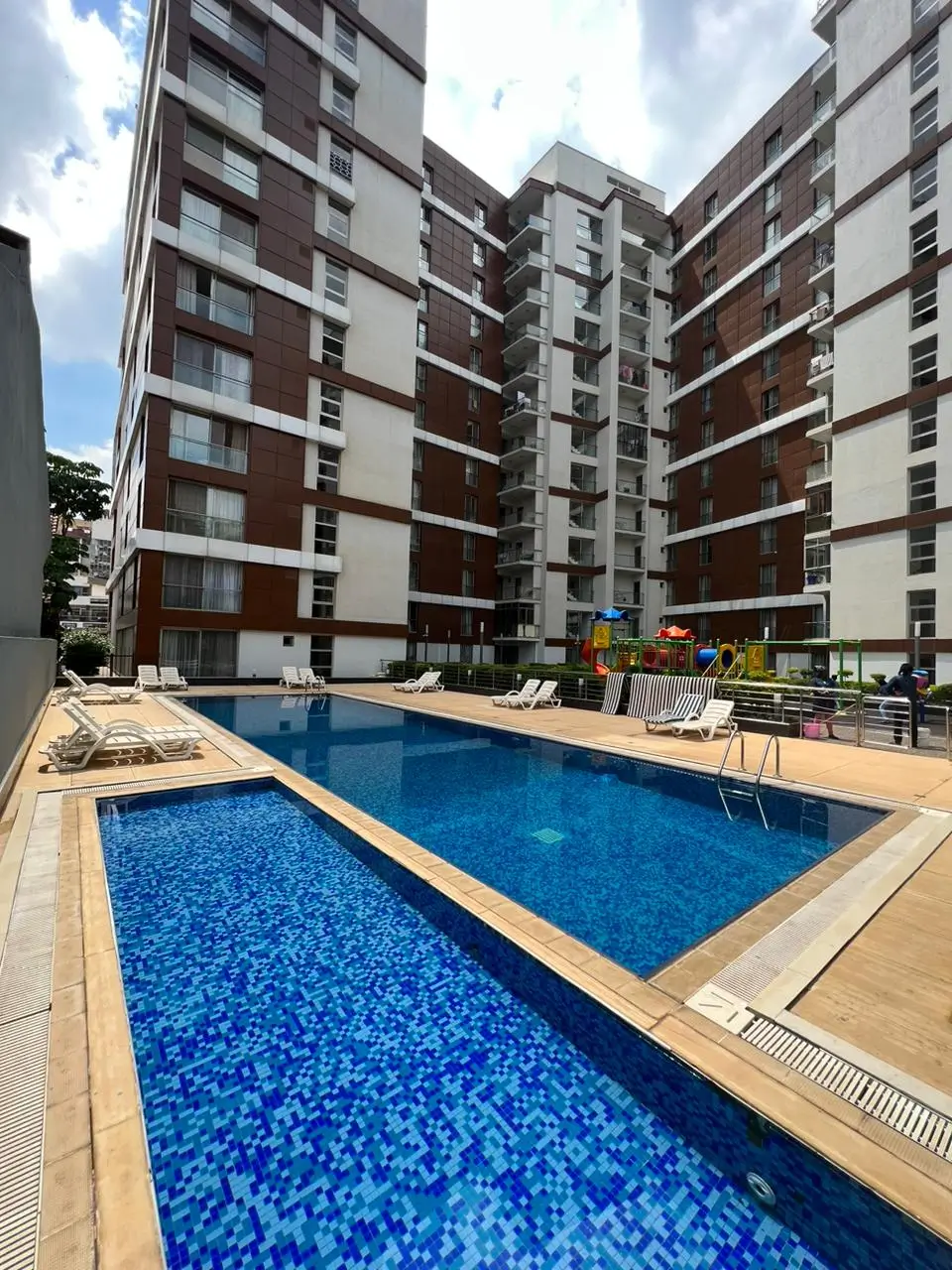 Resort-style swimming pool with bright blue water and deck