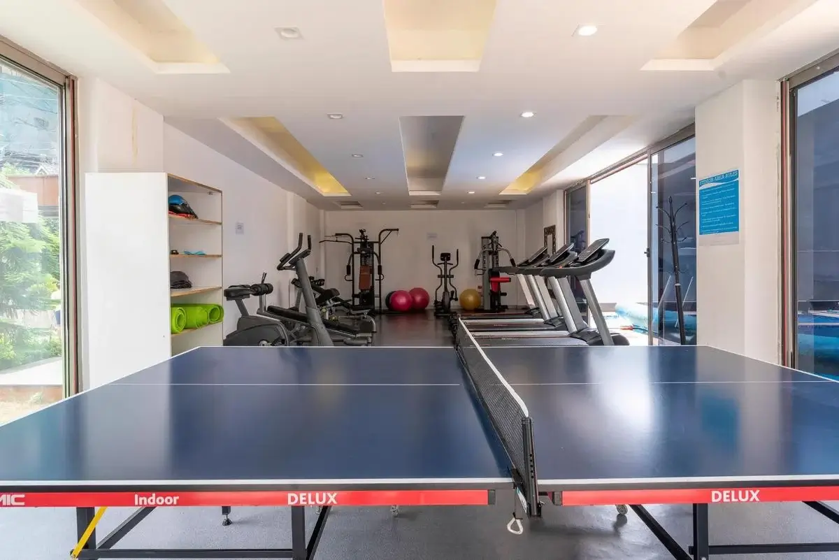 Modern gym with treadmills, exercise bikes, ping pong table