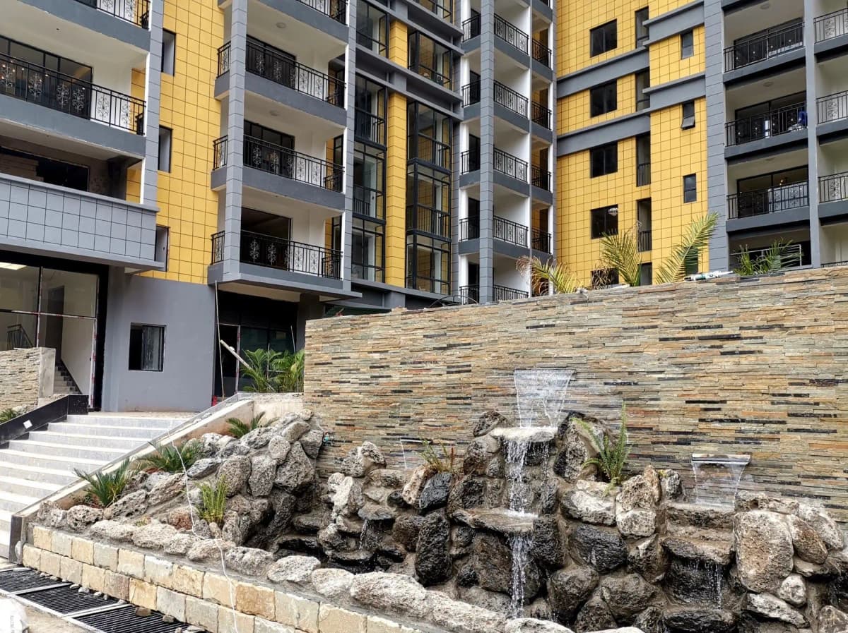 Modern apartment building facade with decorative stone water feature
