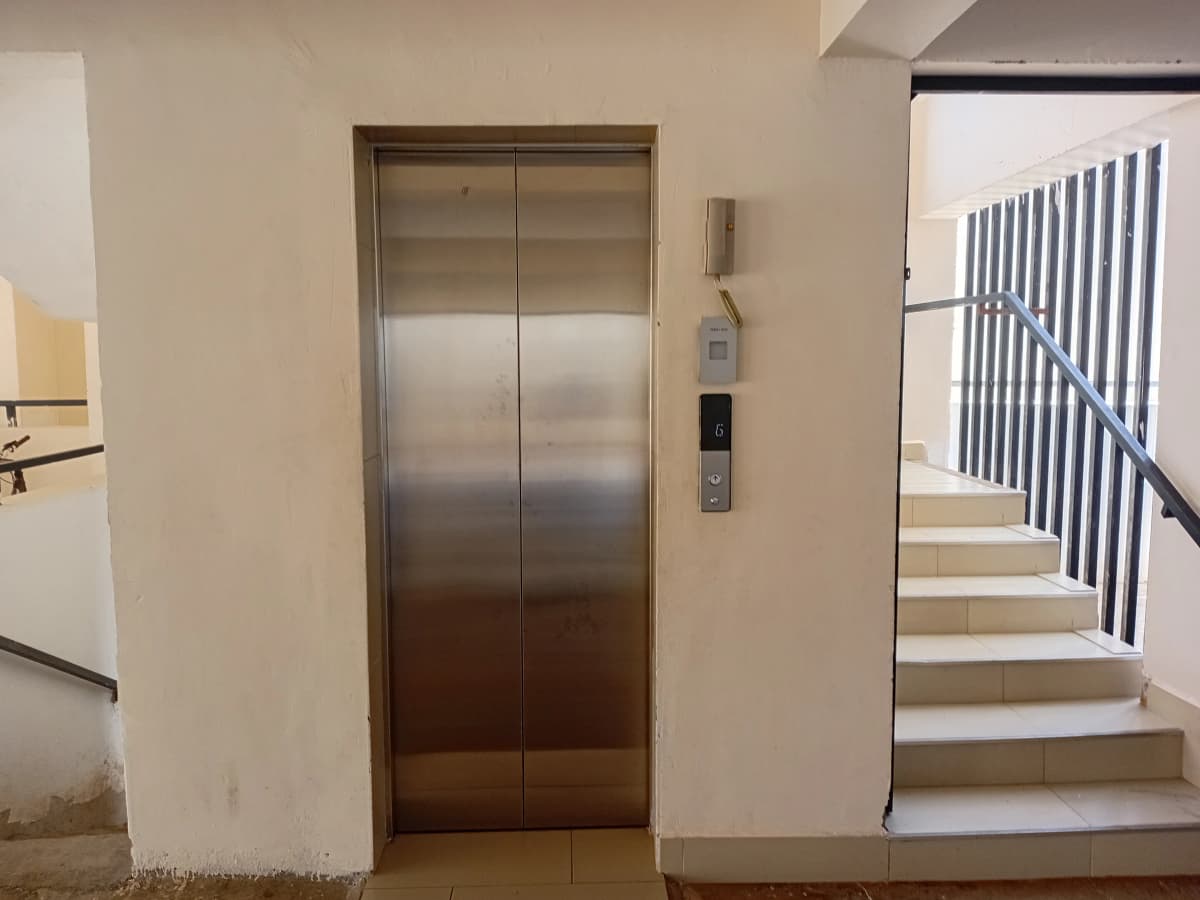 Building lobby with stainless steel elevator and staircase