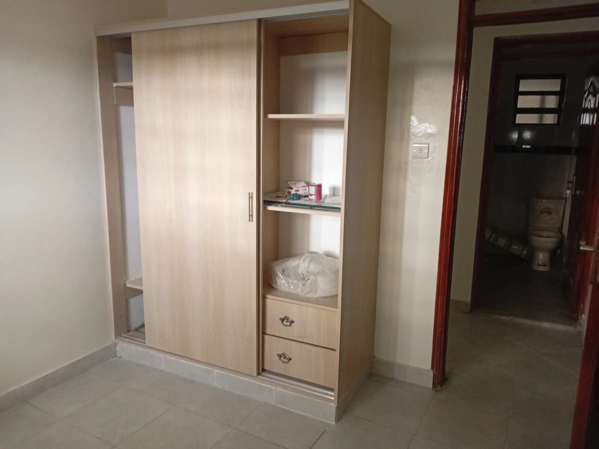 Bedroom with built-in wooden wardrobe and sliding doors