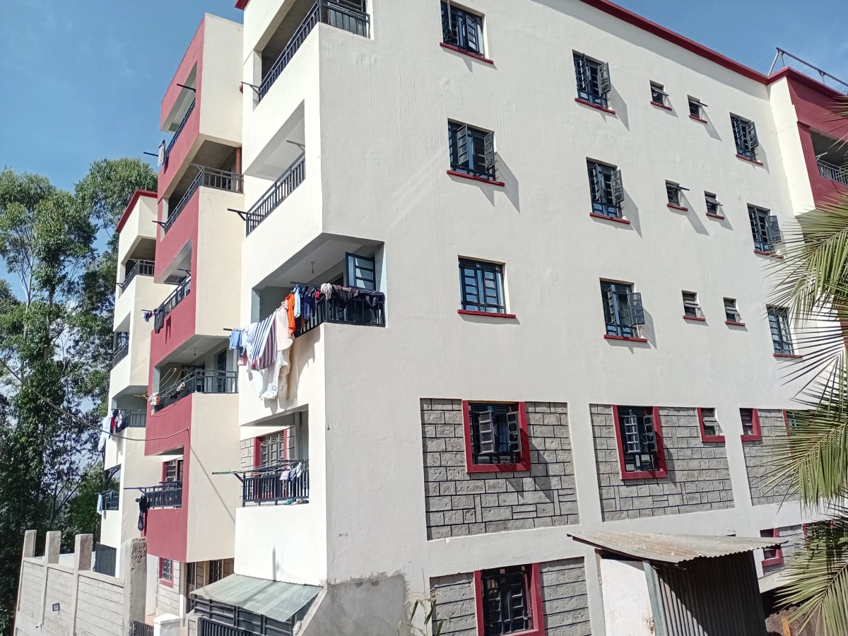 Multi-story residential building with red and white facade
