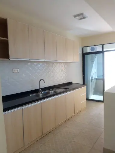 Modern kitchen with cream cabinets and black granite countertops
