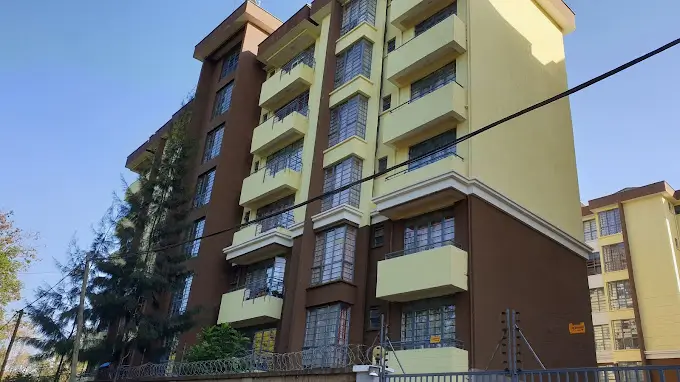 Multi-story residential building with cream and brown facade