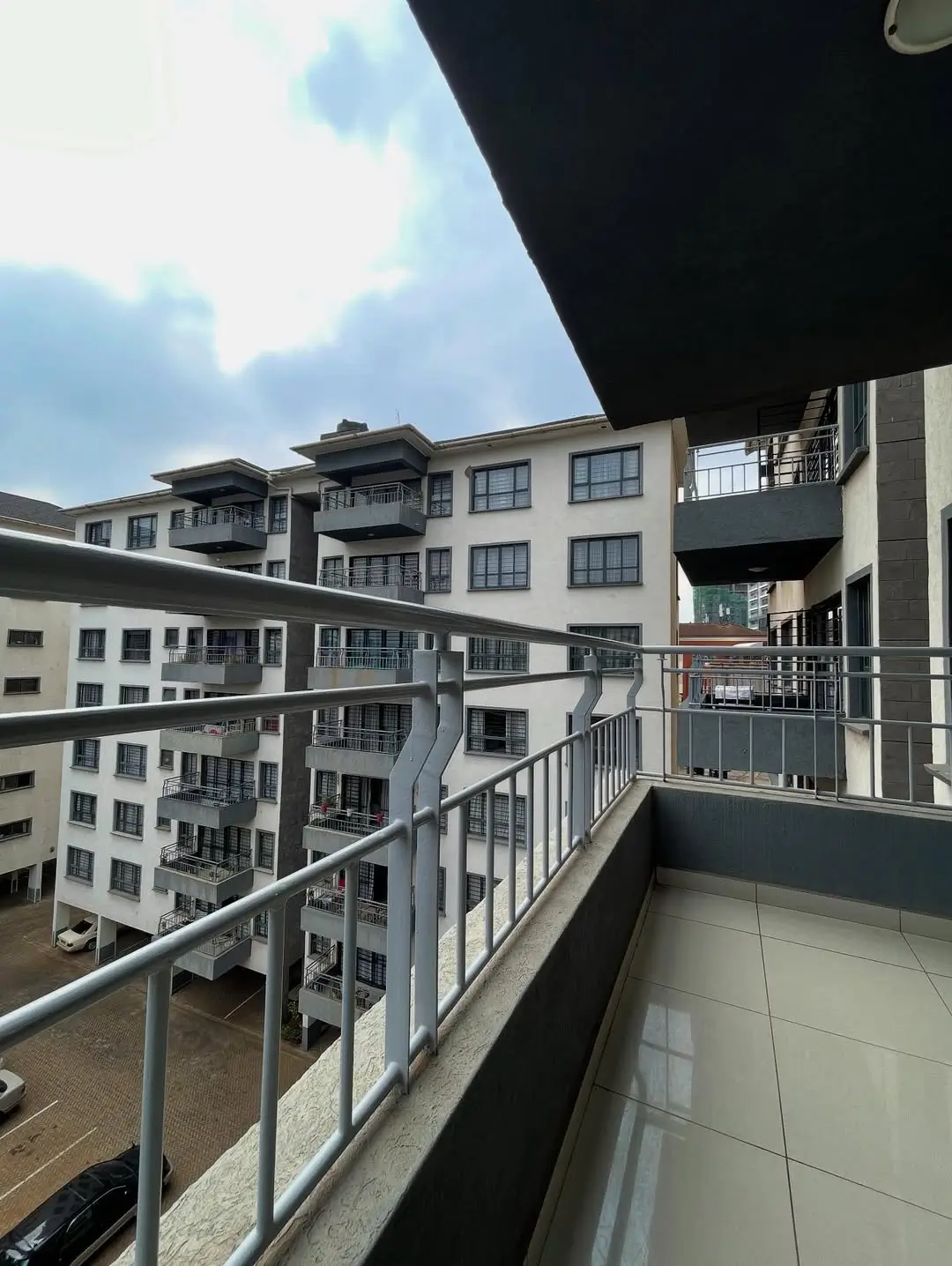 Balcony overlooking residential compound with multiple apartment buildings
