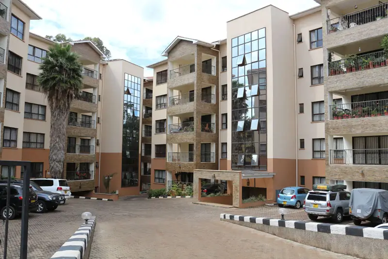 Multi-story residential compound with parking courtyard