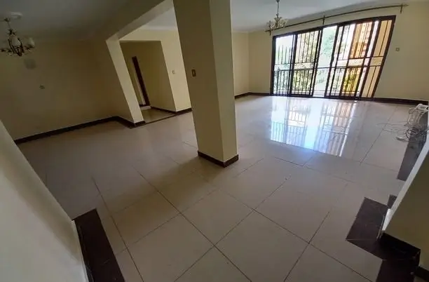 Spacious open-plan living area with polished tile flooring