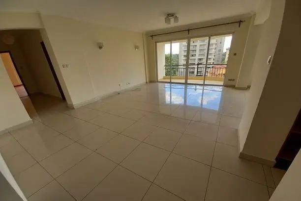 Spacious living room with tiled floors and balcony access