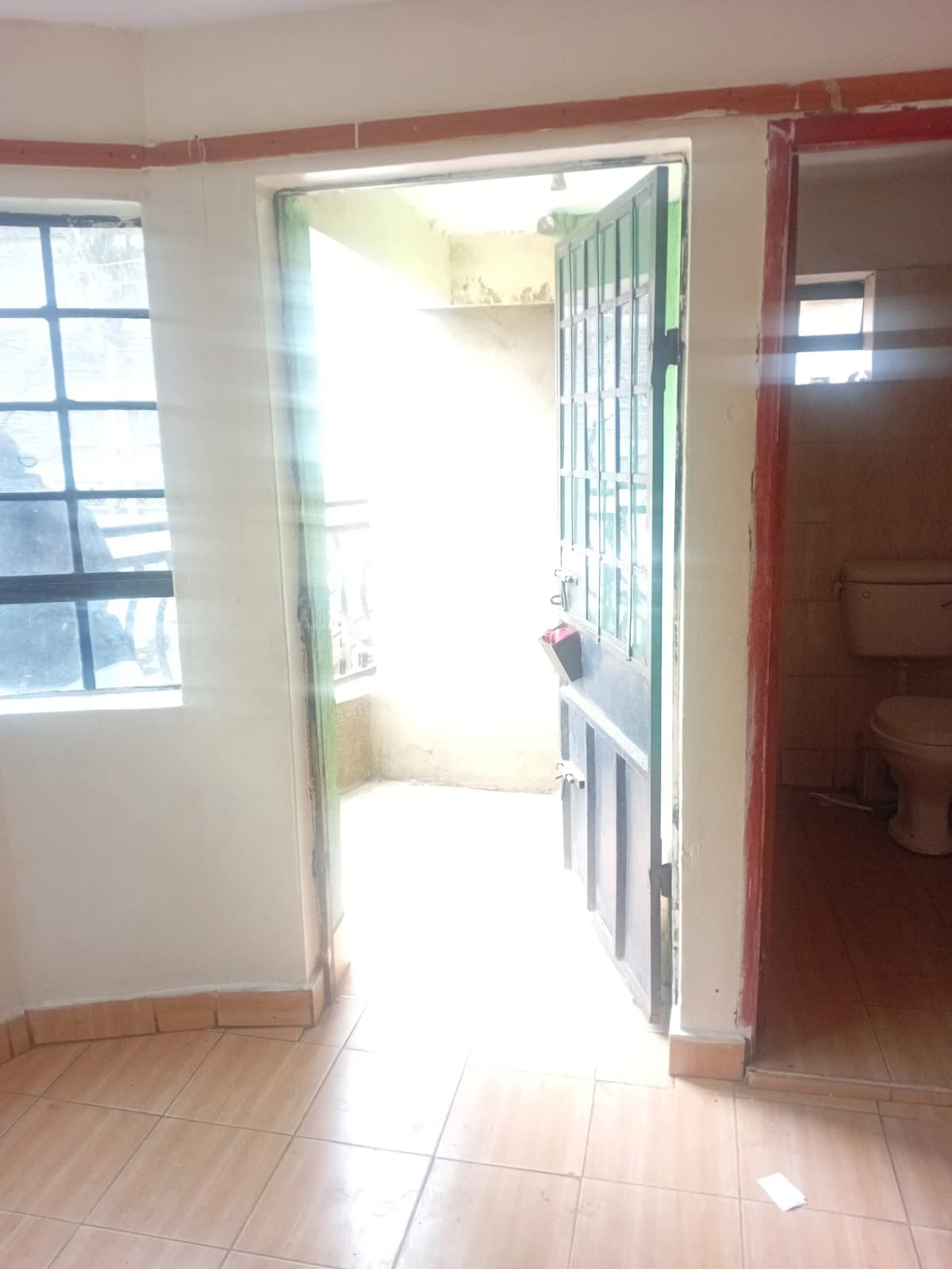 Bright corridor with open door leading to balcony or terrace